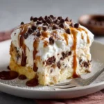Easy cannoli poke cake recipe slice showing layers of moist cake, ricotta mascarpone filling, and chocolate chips