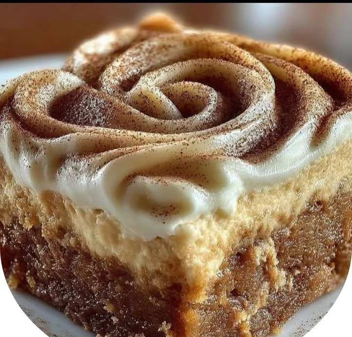 Delicious Pumpkin Spice Gooey Cake topped with cream and autumn spices