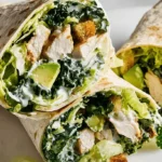 Appetizing chicken Caesar salad wraps, a perfect example of easy lunch ideas, displayed on a clean surface.