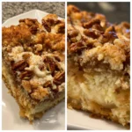 A delicious, layered apple dump cake with a golden-brown streusel topping, creamy glaze, and tender apple filling on a white plate.